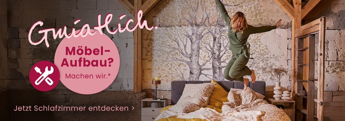 Möbel-Aufbau? Machen wir – Frau springt auf gemütlich gemachtem Bett in rustikalem Schlafzimmer, Text: Jetzt Schlafzimmer entdecken
